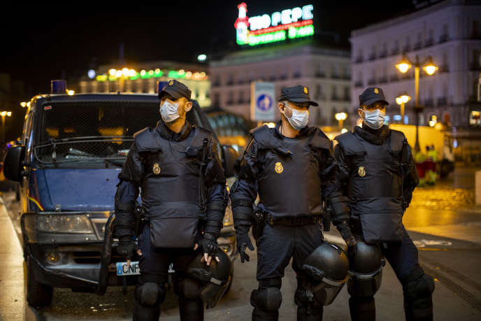 Spanish police officers block access to Puerta Del Sol square in Madrid during a protest against the curfew on October 31.