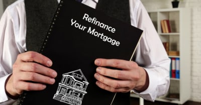 Business concept that means refinance your mortgage with a phrase on paper.