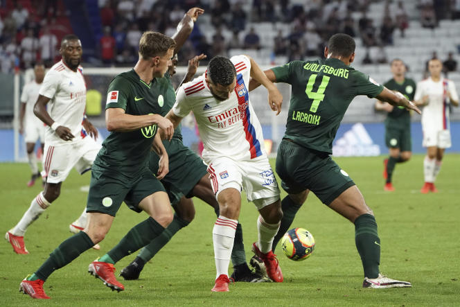 Lyon center Rayan Cherki, center, faces Wolfsburg during the friendly match in Déclines near Lyon, July 17, 2021.