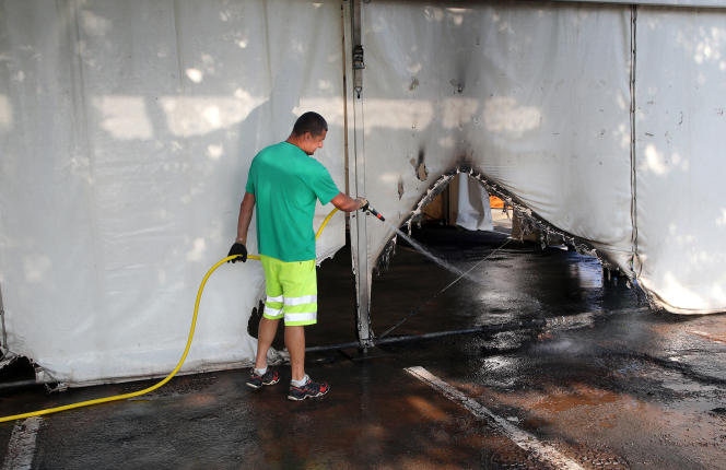 A municipal employee cleans the tent of the Urrugne vaccination center, which burned down over the weekend.