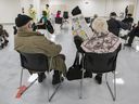 Two Montreal residents sit in the waiting room after receiving COVID-19 vaccinations at the Décarie Square clinic in Montreal on Monday, March 1, 2021.