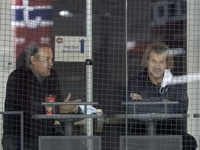 Canadiens general manager Marc Bergevin (right) and assistant general manager Scott Mellanby watch the team's training session Wednesday during training camp at the Bell Sports Complex in Brossard.