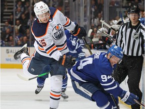 Josh Archibald (15) of the Edmonton Oilers steps aside from a punch from Tyson Barrie (94) of the Toronto Maple Leafs during an NHL game at Scotiabank Arena on January 6, 2020 in Toronto.