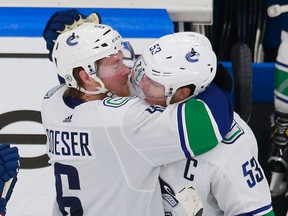 Brock Boeser and Bo Horvat hug during the 2020 NHL playoffs. Horvat said Wednesday that he liked having two power play units. 