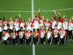 Canada poses with their gold medals following the women's soccer medal ceremony at the Tokyo 2020 Olympic Games.