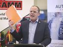 Chris Lewis, MP Essex holds up a petition during a press conference on Friday March 19, 2021, at Cavalier Tool and Manufacturing Ltd. in Windsor.  Lewis retained Essex in Monday's election, but is in hospital after falling off a horse.