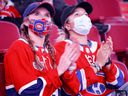 Two Habs fans applaud the Montreal Canadiens for the annual Reds and Whites fight in Montreal, Sunday, Sept. 26, 2021.