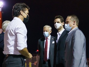 Prime Minister Justin Trudeau welcomes Michael Kovrig and Michael Spavor back to Canada at the Calgary airport on Saturday morning.