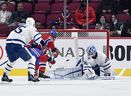 Canadiens' Christian Dvorak scores a goal against Maple Leafs goalkeeper Jack Campbell during the first period at the Bell Center on Monday, Sept. 27, 2021. 