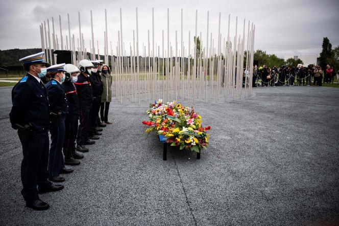 Police officers and firefighters in front of the monument in tribute to the victims of the industrial explosion of September 2001 at the AZF chemical plant.