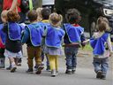 Children from the nursery walk down a street in Plateau-Mont-Royal on September 2, 2020.