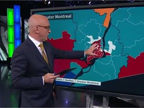 CBC's David Cochrane uses a touch screen to display the results of the federal election on Monday, September 20, 2021.