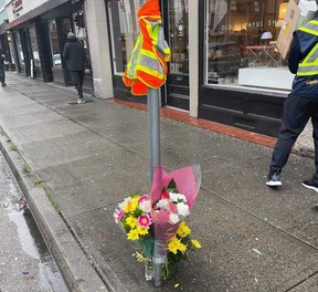 Flowers are left at a makeshift memorial on West Cordova Street for Vancouver bus driver Charanjit Parhar.  The Coast Mountain Bus Company employee died after being trapped between two transit buses in downtown Vancouver on Monday.