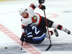 Winnipeg Jets forward Nikolaj Ehlers (below) becomes entangled with Ottawa Senators forward Shane Pinto in the NHL exhibition game at the Canada Life Center in Winnipeg on Sunday.