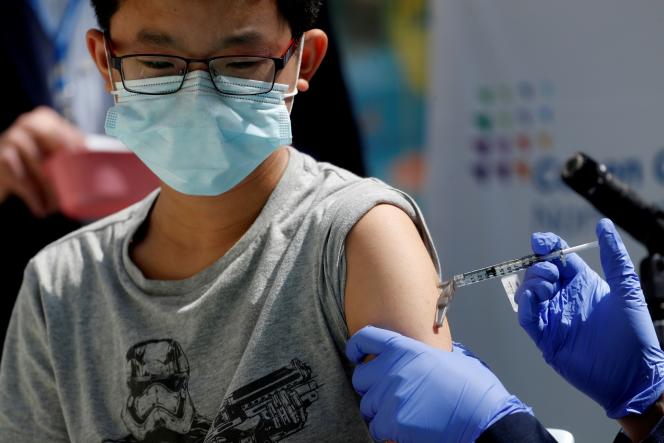 A teenager receives an injection of the Covid-19 vaccine in New Hyde Park, New York on May 13, 2021.