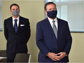 Prime Minister Jason Kenney stands in front of Jason Copping, the newly appointed Minister of Health, during a press conference in Edmonton, Tuesday, September 21, 2021.