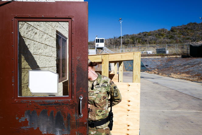 US base at Guantanamo, 2017. A guard hides her face during a visit organized for the media.