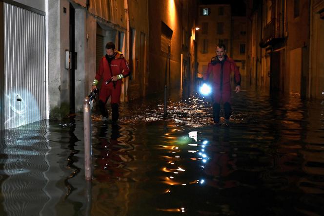 Firefighters patrol the flooded streets of Agen on September 8, 2021.
