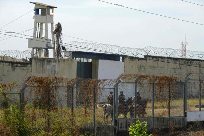 Mounted policemen patrol the prison in Guayaquil, Ecuador where more than 100 prisoners have been killed in gang clashes.