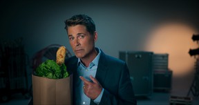 Rob Lowe demonstrates the old baguette trope on the grocery bag.