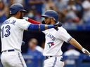 Breyvic Valera of the Blue Jays celebrates with Lourdes Gurriel Jr. after hitting a home run against the Oakland Athletics at the Rogers Center on September 4, 2021 in Toronto.