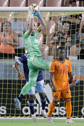 Vancouver Whitecaps goalkeeper Maxime Crepeau saves in front of Houston Dynamo forward Carlos Darwin Quintero in the first half.