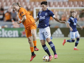 Houston Dynamo midfielder Griffin Dorsey, left, blocks a pass attempt by Vancouver Whitecaps midfielder Patrick Metcalfe during the first half on Wednesday, September 29.