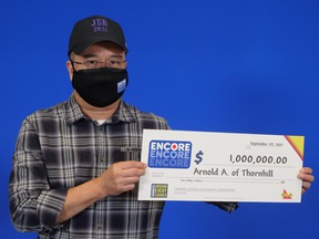 Thornhill's Arnold Agulto with his $ 1 million winnings playing Encore.