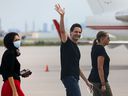 Former diplomat Michael Kovrig, his wife Vina Nadjibulla, and sister Ariana Botha walk after their arrival on a Canadian air force plane after their release from detention in China, at Toronto's Pearson International Airport on September 25, 2021. .  