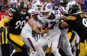 Bills QB Josh Allen is caught in the clutches of the Steelers' Cameron Heyward (right) as TJ Watt closes in yesterday.  fake images
