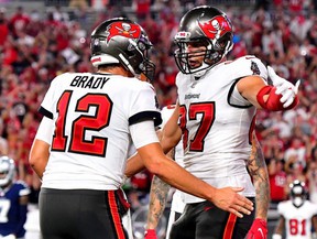 Tom Brady (left) and Rob Gronkowski of the Tampa Bay Buccaneers celebrate a touchdown during their team's 31-29 victory over the Dallas Cowboys at Raymond James Stadium on September 9, 2021 in Tampa, Florida.
