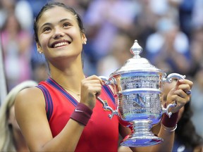 Emma Raducanu of Great Britain celebrates with the championship trophy after her match against Leylah Fernandez of Canada (not pictured) in the women's singles final on day 13 of the 2021 US Open tennis tournament at the USTA Billie Jean King National Tennis Center.