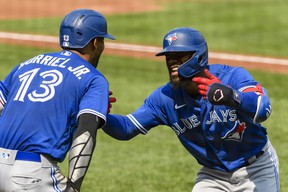The Blue Jays' Teoscar Hernández (right) and teammate Lourdes Gurriel Jr. after hitting a Grand Slam home run during the third inning at Oriole Park at Camden Yards on Sunday, Sept. 12, 2021.