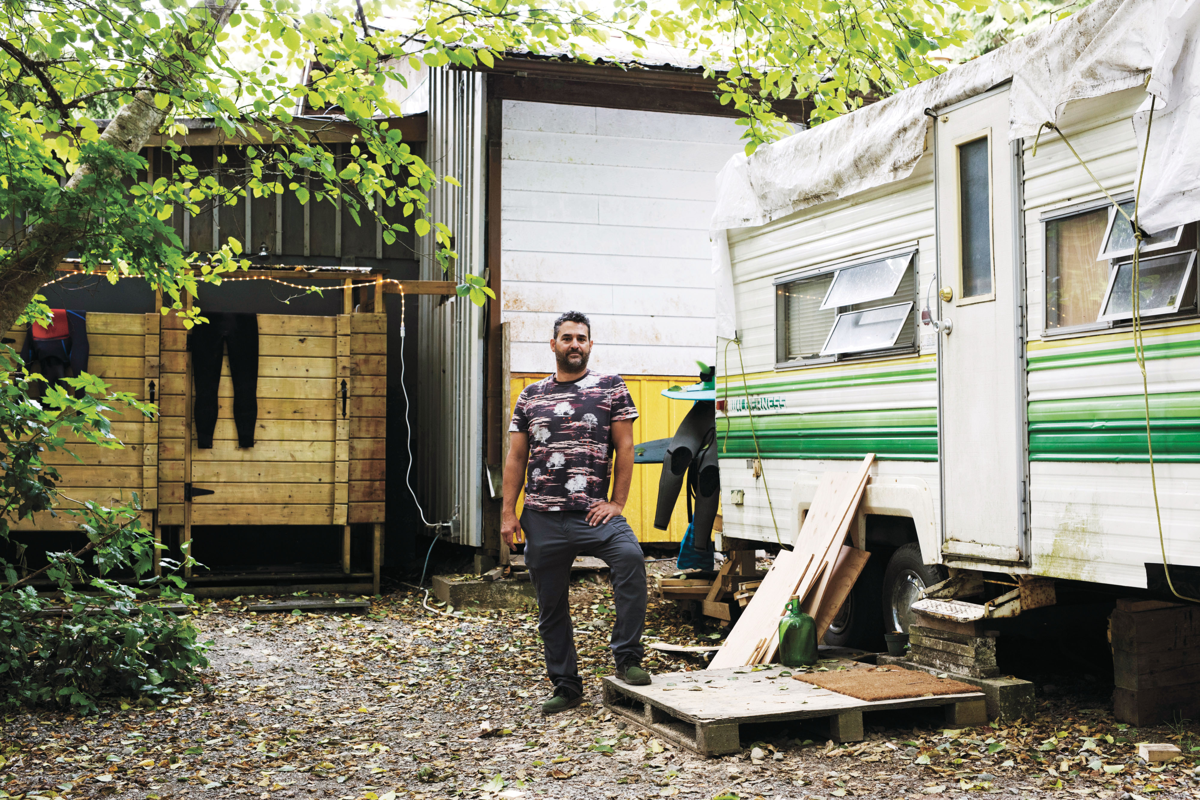 Crab Apple camp owner Mathieu Amin poses for a photo at the residential camp in Tofino on July 8, 2021. The Tofino community mascot is a VW van with a surfboard on the roof, he described. "They are using it for marketing, but they don't really want it." he said.  (Photograph by Melissa Renwick)