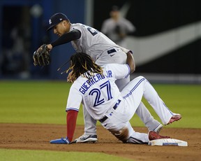 New York Yankees second baseman Gleyber Torres takes out Blue Jays first baseman Vladimir Guerrero Jr. at second base during the sixth inning at the Rogers Center on Tuesday, Sept. 28, 2021.