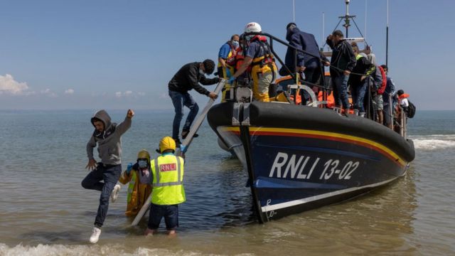 A group of around 40 migrants arrive via the RNLI (Royal National Lifeboat Institution) at Dungeness beach on August 4, 2021.