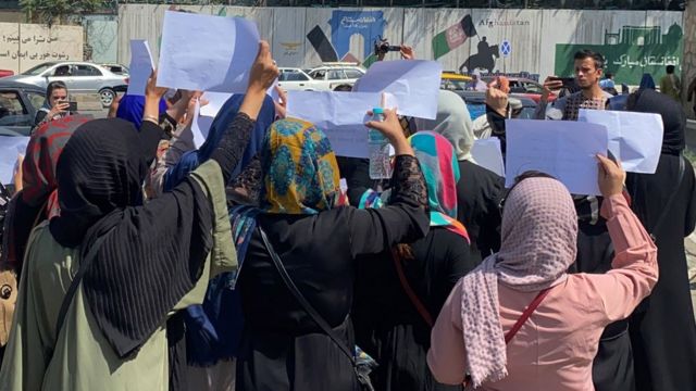 Afghan women hold placards as they call on the Taliban to preserve their rights to work and education, in Kabul on September 3, 2021.