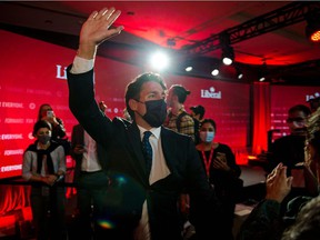 Canadian Prime Minister Justin Trudeau greets as he leaves the Fairmount Queen Elizabeth Hotel after delivering his victory speech in Montreal, Quebec, early September 21, 2021.