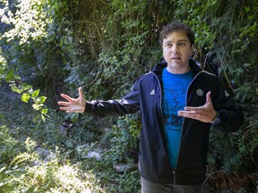Ward 2 Coun.  Fabio Costante inspects a heavily overgrown and neglected alley between Bridge and Partington avenues south of University Avenue West, Tuesday, Sept. 28, 2021.