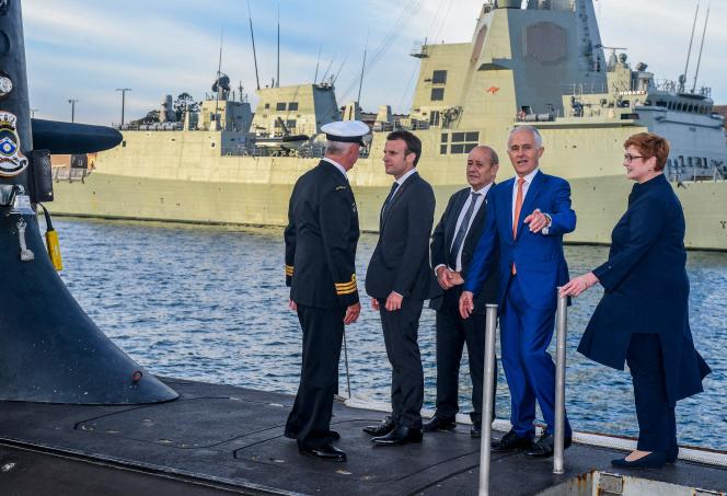 President Emmanuel Macron and then Australian Prime Minister Malcolm Turnbull (center) on the deck of a Collins-class submarine, May 2, 2018, in Sydney.