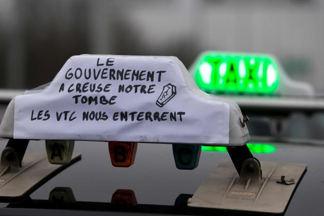 Taxi drivers take part in a demonstration to protest against the competition of the taxi application company Uber, in the suburbs of Paris, on January 26, 2015.