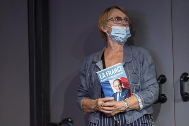 An activist holds Eric Zemmour's book during the meeting at the Palais des Congrès in Nice, September 18, 2021.