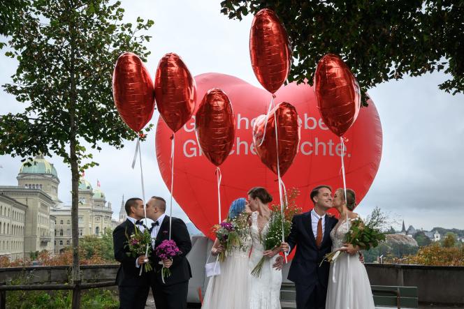 Couples pose during a photo op during the day of the nationwide referendum on marriage for all, in Bern, on September 26, 2021.