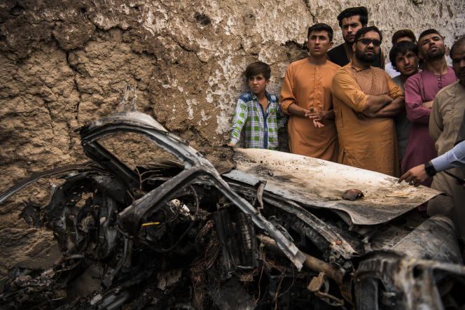 Residents of Kabul crowd around the wreckage of a vehicle destroyed by an American drone on August 29, 2021. Ten civilians were killed in the strike according to the New York Times.