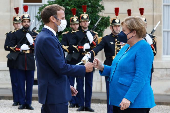 President Emmanuel Macron and German Chancellor Angela Merkel during a dinner at the Elysee Palace, September 16, 2021.