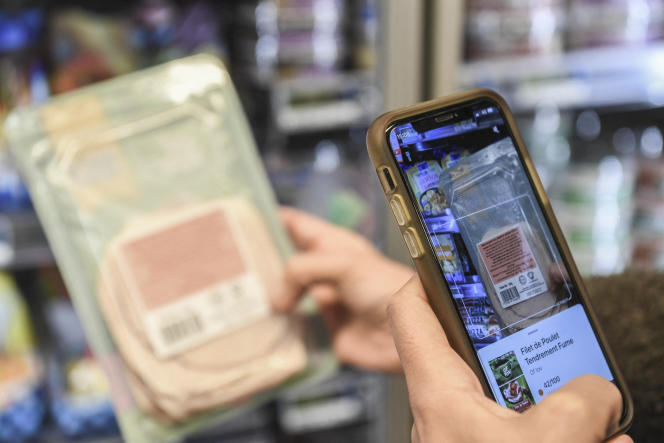 A customer scans a product using the Yuka app on November 20, 2020 in Paris.