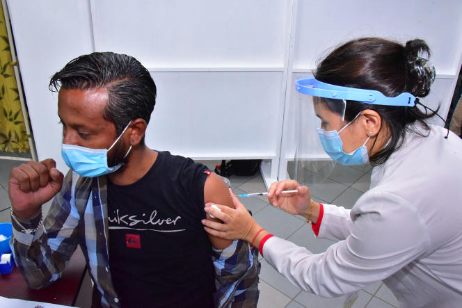 An employee of a quarantine center receives an injection of the Covid-19 vaccine at the Victoria hospital in Quatre-Bornes, Mauritius, in January 2021.