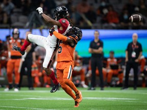 Ryan Davis of the Ottawa Redblacks, left, fails to catch as TJ Lee of the BC Lions defends during the second half of a CFL football game in Vancouver on Saturday, Sept. 11, 2021.