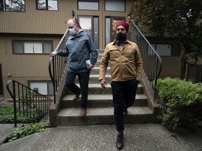 NDP leader Jagmeet Singh and local candidate Jim Hanson knock on the door to go out to vote in Burnaby on Monday, September 20, 2021.
