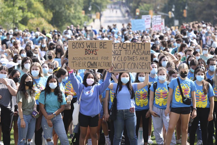 Students hold up a sign that says children will be held accountable for their actions.